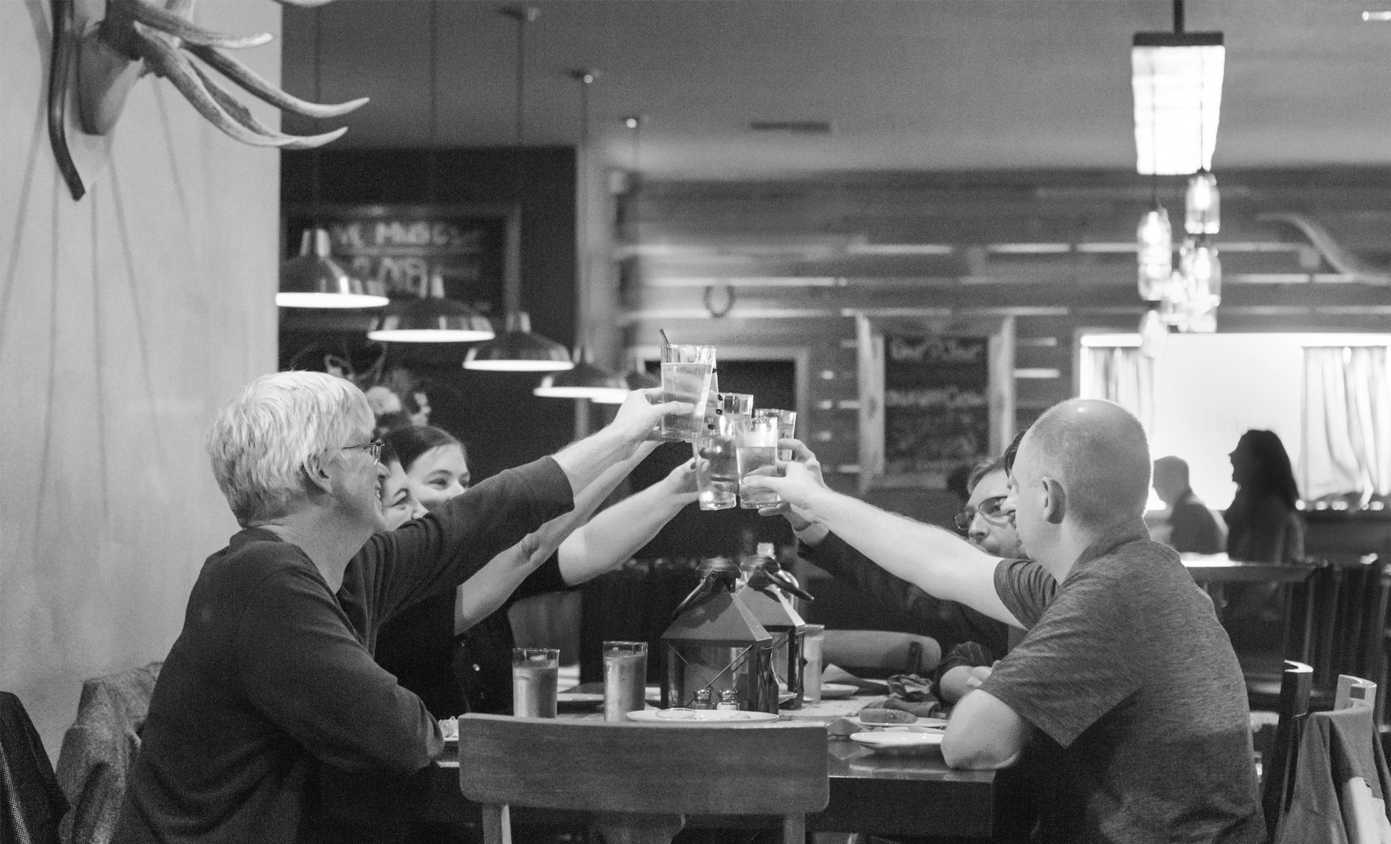 Flowerpot team photo cheering with their glasses raised in a circle